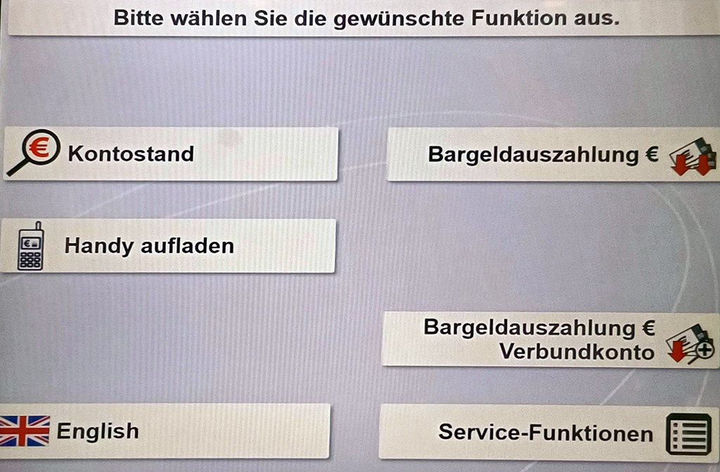 Screenshot eines Menüs auf einem Geldautomaten mit verschiedenen Funktionsbuttons. Oben rechts "Bargeldauszahlung", darunter "Bargeldauszahlung Verbundkonto" sowie weitere Felder.